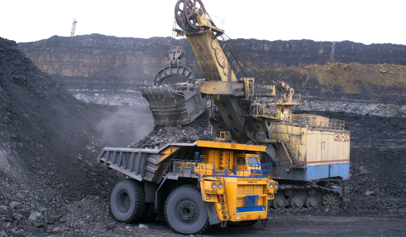 Mining operations with heavy machinery, excavators, and specialized bolting solutions for extreme conditions