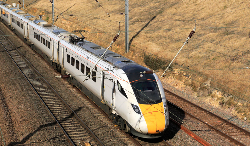 Railway systems with trains, bogies, and specialized bolting solutions for shock absorption